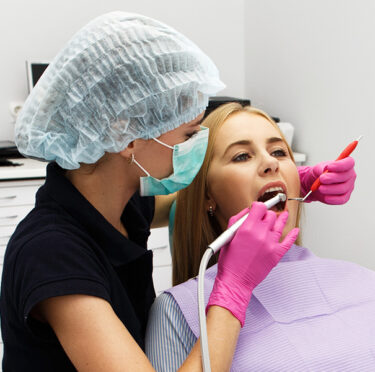 dentist treating patient mouth in clinic