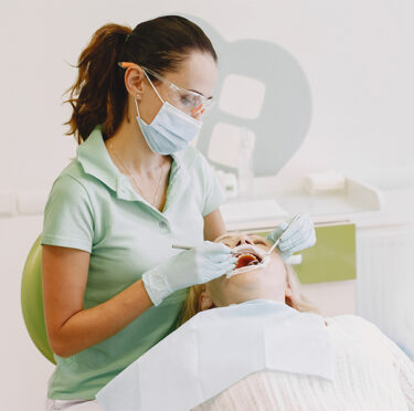 dentist doing dental procedure in clinic